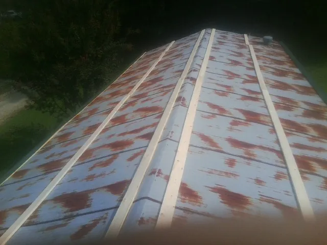 Rusted metal roof panels with new wood purlins before replacement — Storm Damage Roof Repair in Stateline by Roofing Brothers
